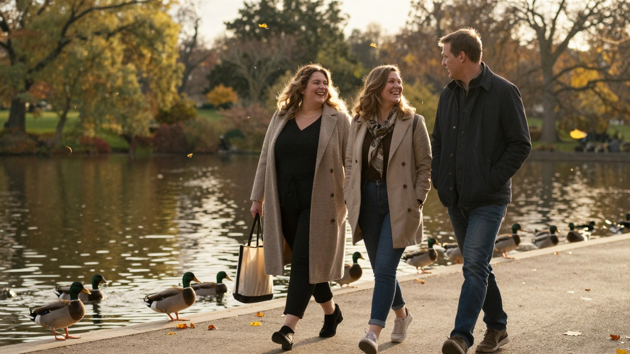 A curvy woman and client walking together in Hyde Park during golden hour, laughing beside the water.