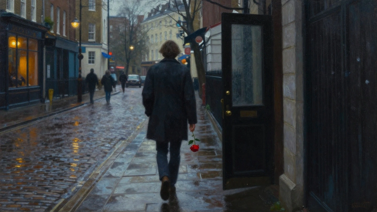 A solitary figure walking away from a shadowy doorway in a rainy London street, holding a red rose.