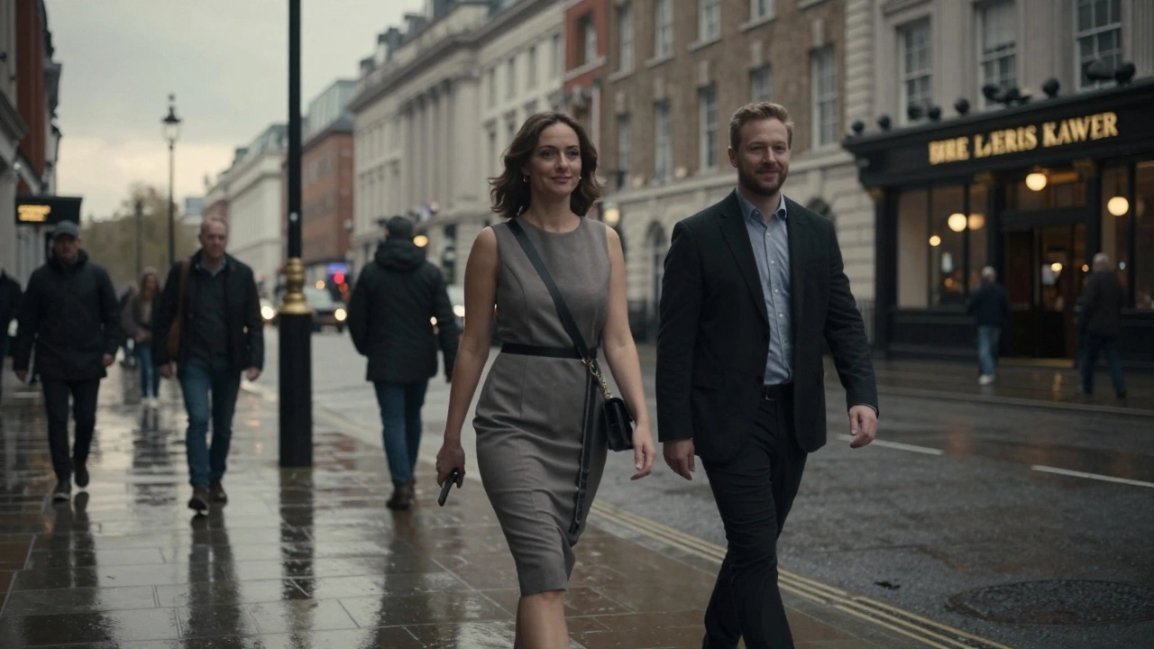 A woman and man walking together along the Thames at dusk, enjoying a calm evening.