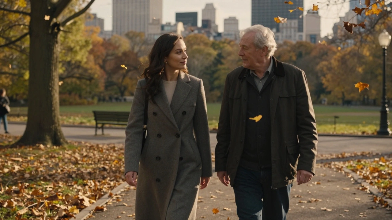 Woman and older man walking together in a park at sunset, sharing quiet conversation.