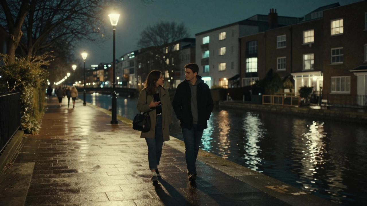 A couple walking peacefully along Regent’s Canal in East London under soft streetlights.