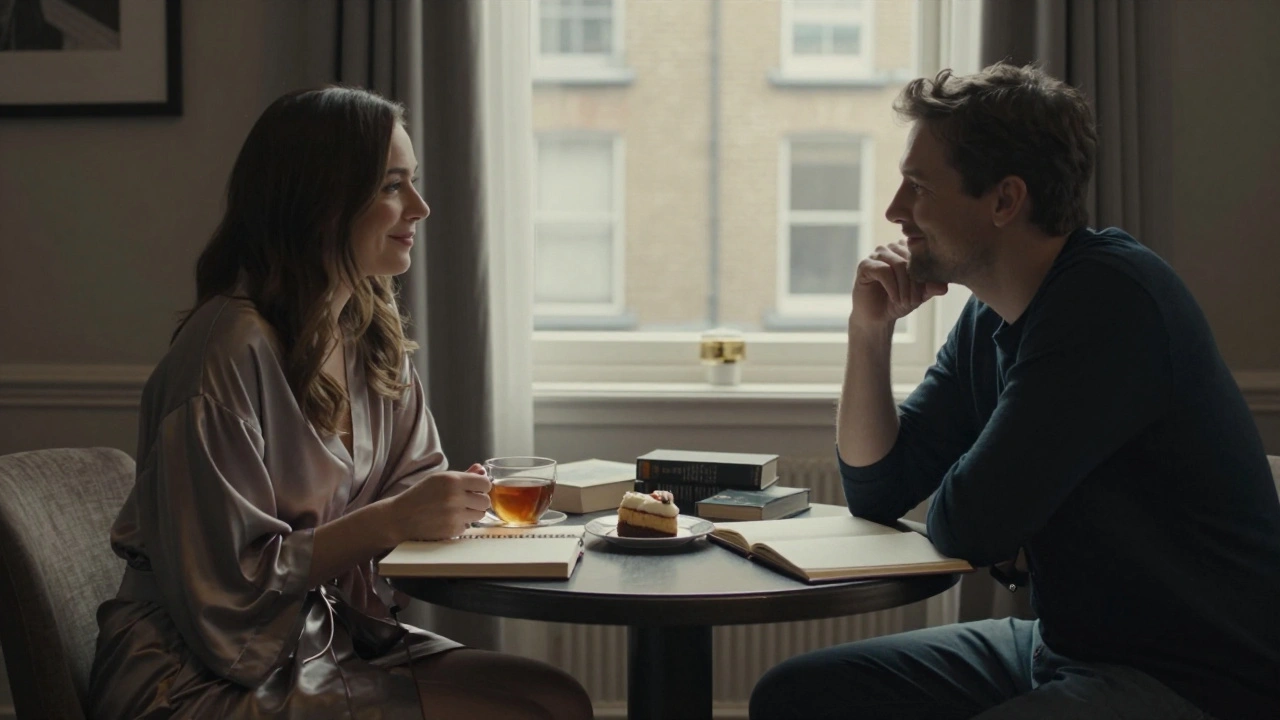 Two people having a quiet, respectful conversation over tea in a hotel room.